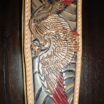 Détail oiseau sur une sangle de guitare